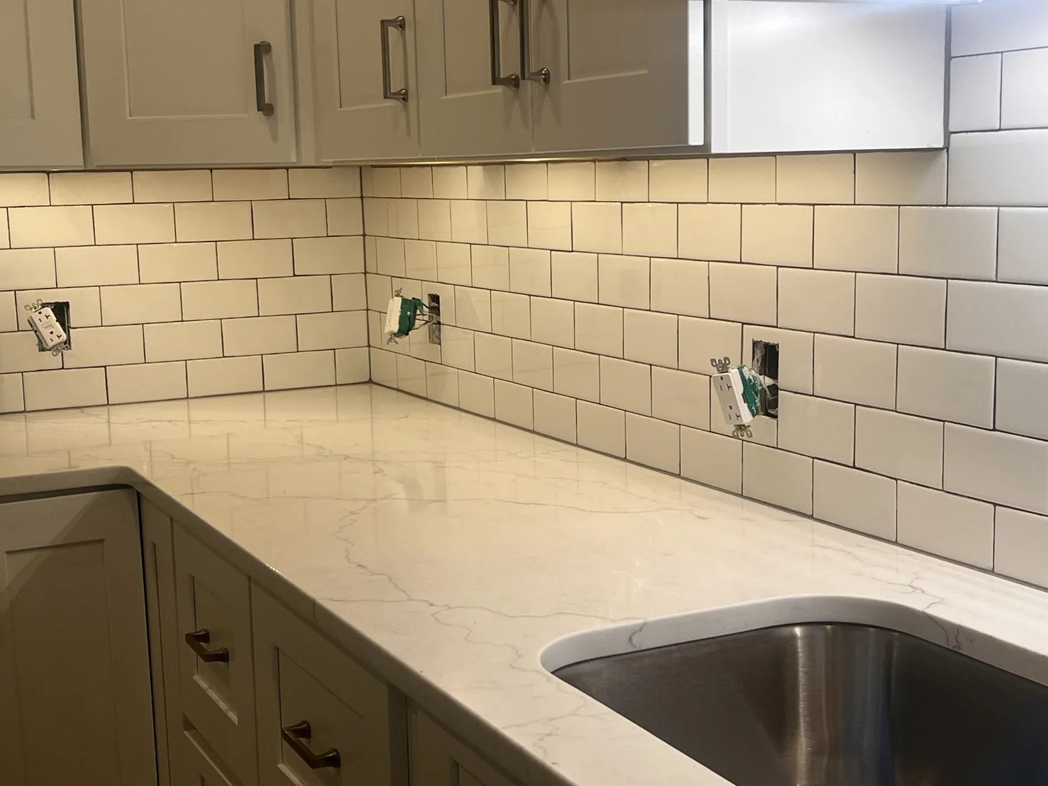 Actual kitchen backsplash tile and under-cabinet lighting installation